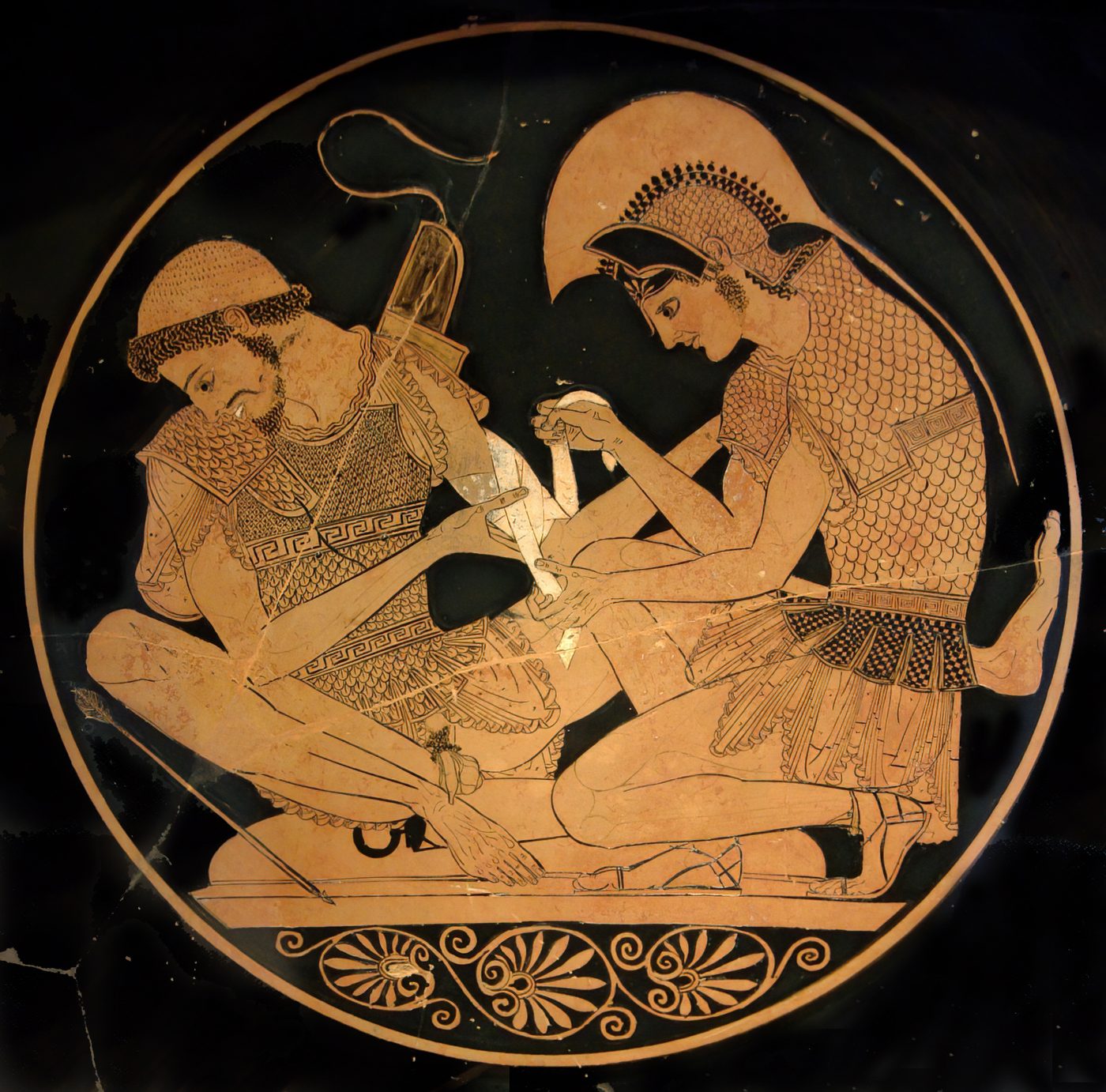 An illustration on an ancient vase showing two soldiers in tunics and sandals. They are sitting down and one is wrapping the other's arm in a bandage.